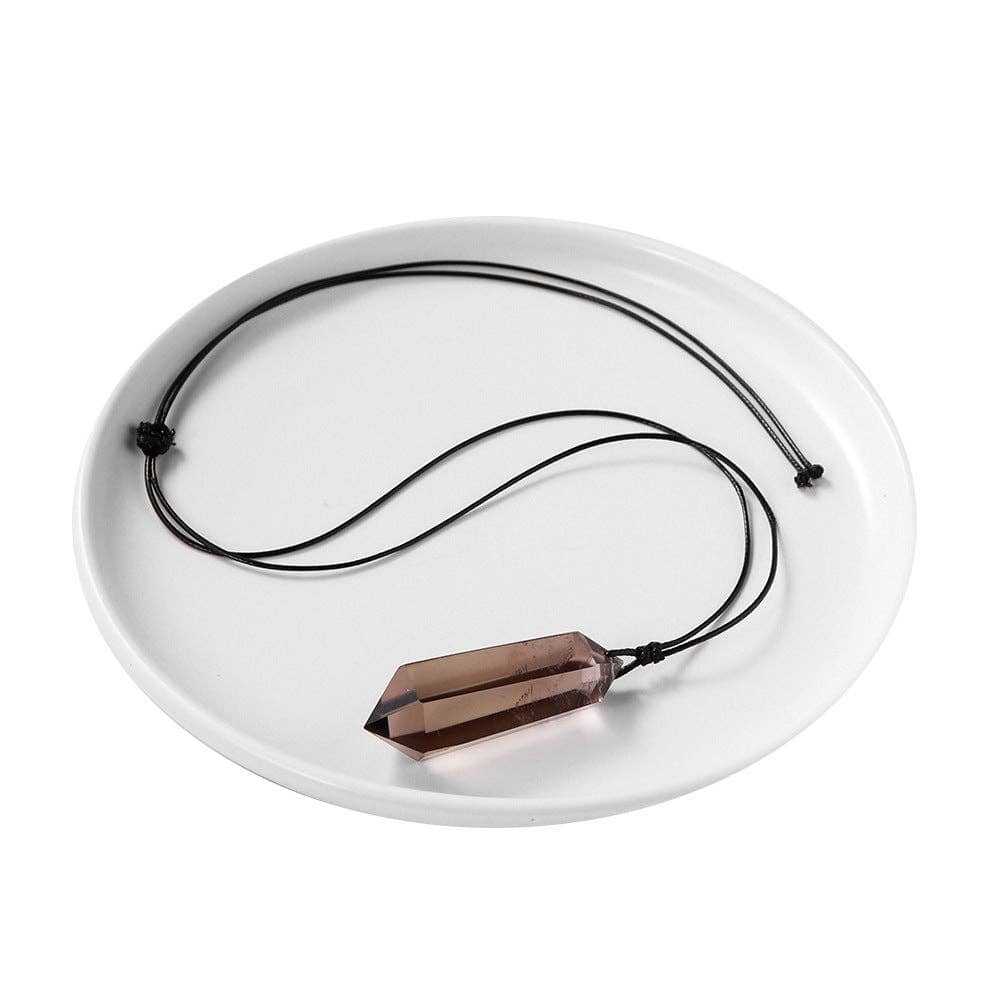 Smoky Quartz Pendant on a black cord displayed on a white plate for a sleek presentation