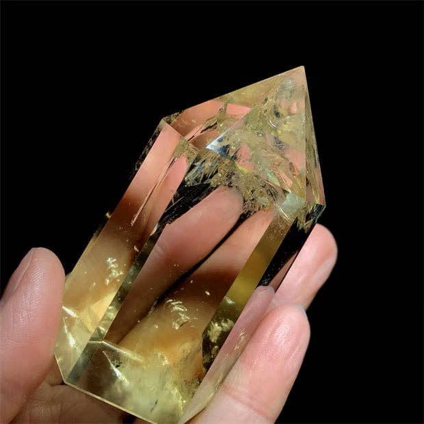 Handheld AAAA Grade Natural Brazilian Citrine Tower showcasing its beautiful clarity and vibrant color