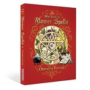 The Book of Flower Spells by Cheralyn Darcey featuring a pentagram and floral designs on a vibrant red cover