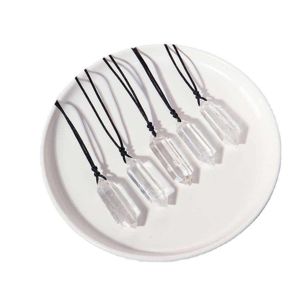 Natural Clear Quartz Crystal Necklace on a white plate showcasing multiple unique crystal designs