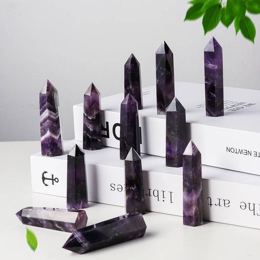 Multiple Natural Dream Amethyst Towers in varying sizes displayed on a white surface for spiritual decor