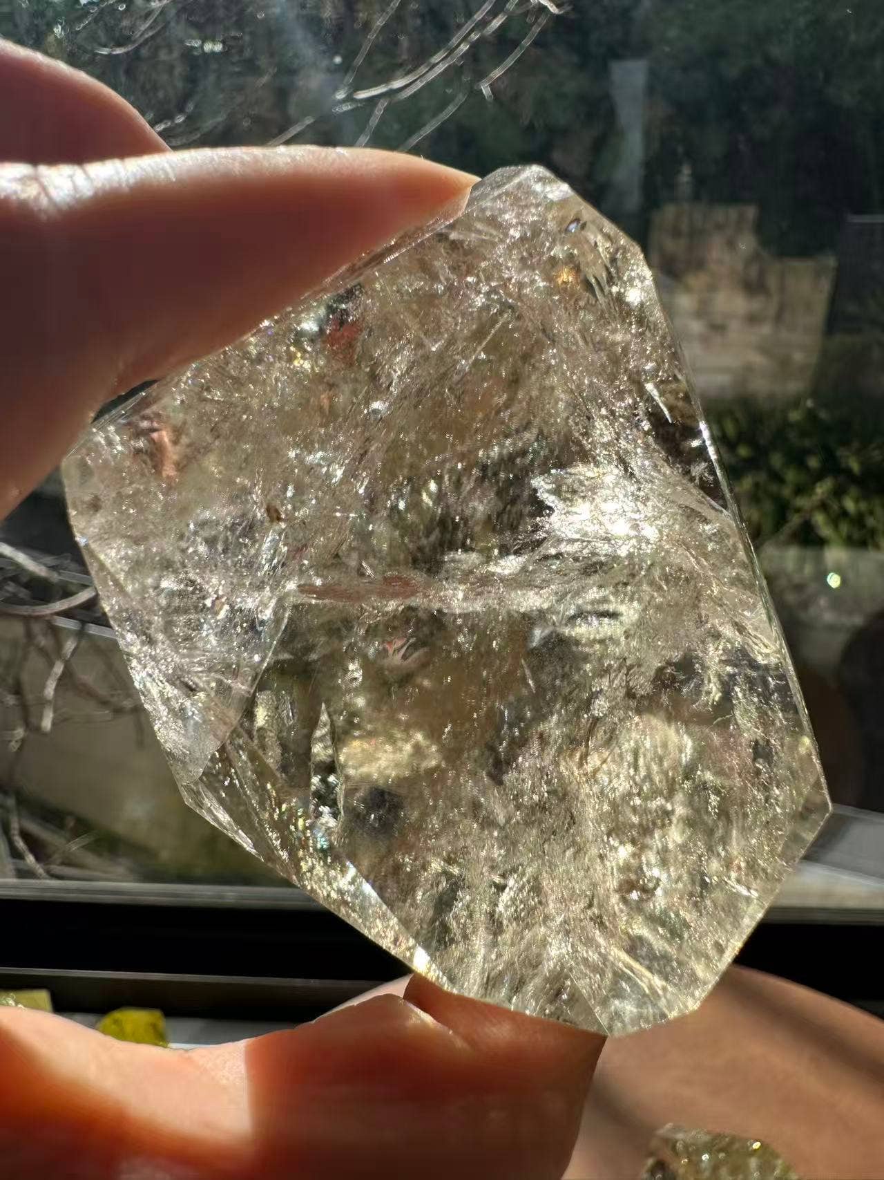 Hand holding a Brazilian Golden Healer Quartz Freeform with sparkling clarity and unique natural shape