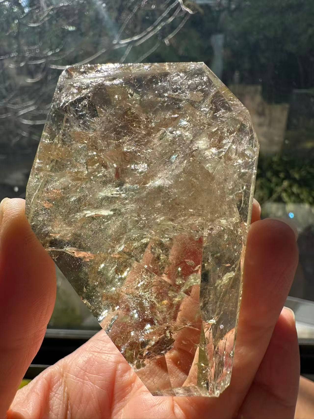 Hand-held Brazilian Golden Healer Quartz Freeform showing its natural clarity and unique shape