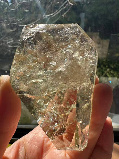 Hand-held Brazilian Golden Healer Quartz Freeform showing its natural clarity and unique shape