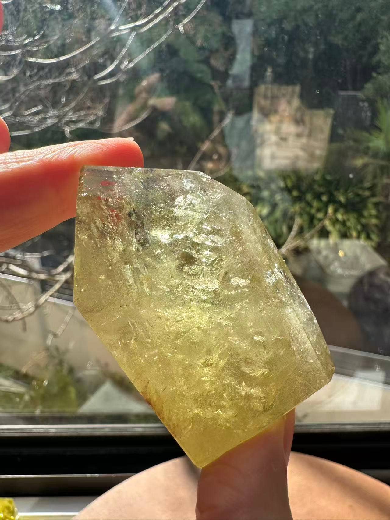 Handheld Brazilian Golden Healer Quartz Freeform with natural inclusions displaying a bright, translucent yellow color