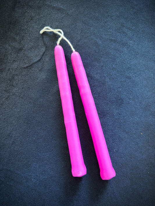 Two hot pink Small Spell Candles from Nimbin Candles, perfect for rituals and intentions