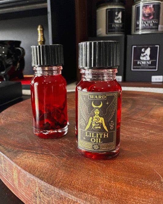The Crow and Cauldron - 10ml Curio Oil - Lilith in a glass bottle with red liquid and herbal ingredients