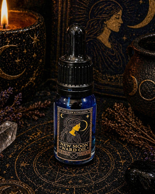 The Crow and Cauldron - 10ml Curio Oil - New Moon in a blue bottle surrounded by mystical decor