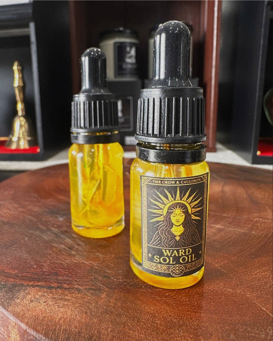 The Crow and Cauldron - 10ml Curio Oil - Ward Sol in a glass bottle with a dropper on a wooden surface