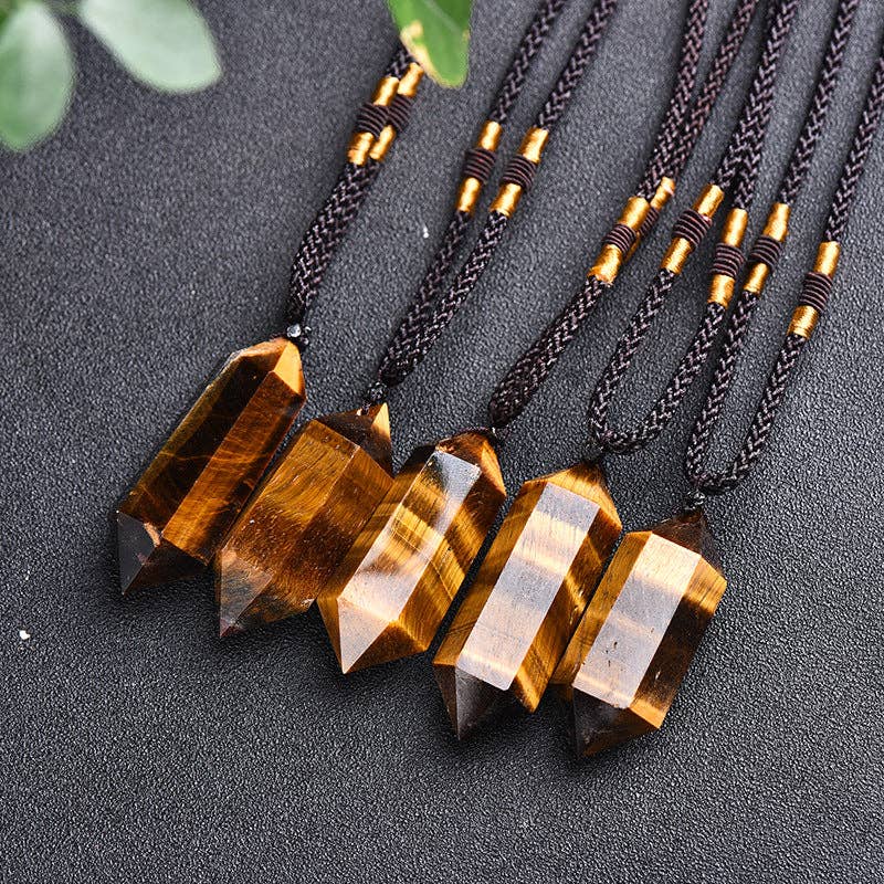Tiger's Eye Crystal Pendant on braided cord, featuring unique facets and a natural finish.